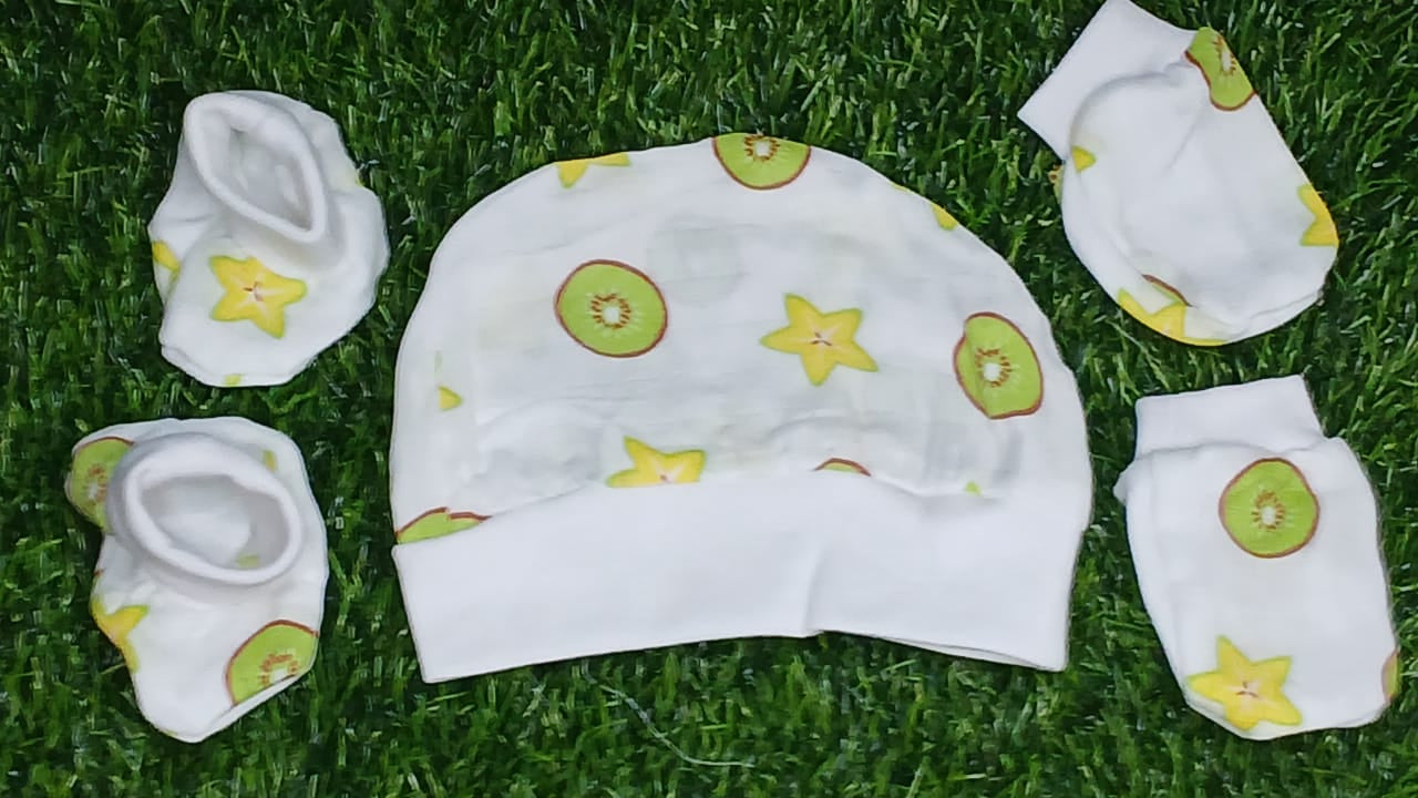Baby hat with green and yellow patterns on grass