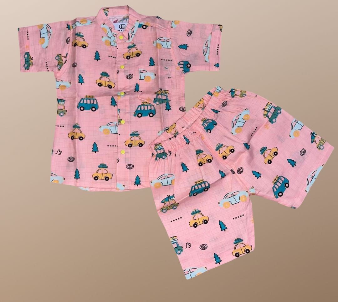 Pink children's pajama set with vehicle pattern on a beige background