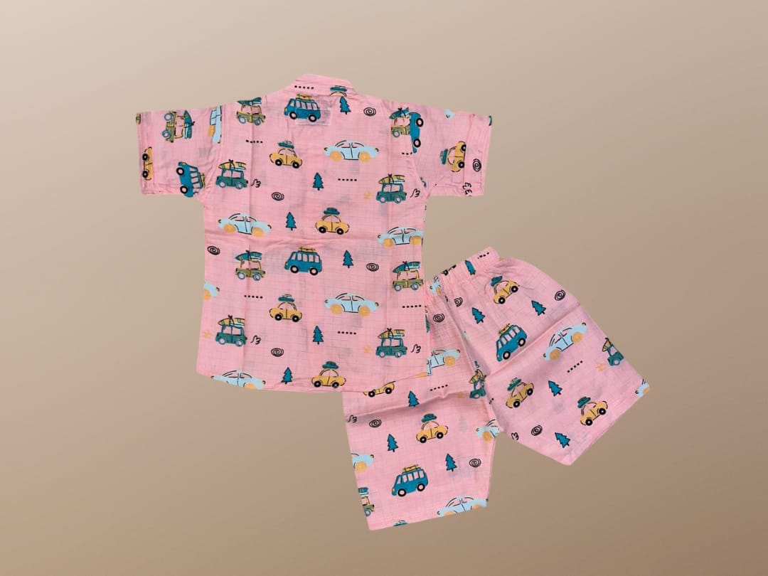 Pink children's pajama set with vehicle pattern on a beige background