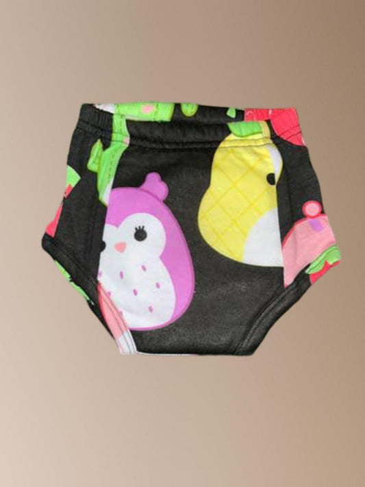 Colorful children's diaper with cartoon penguin design on a beige background