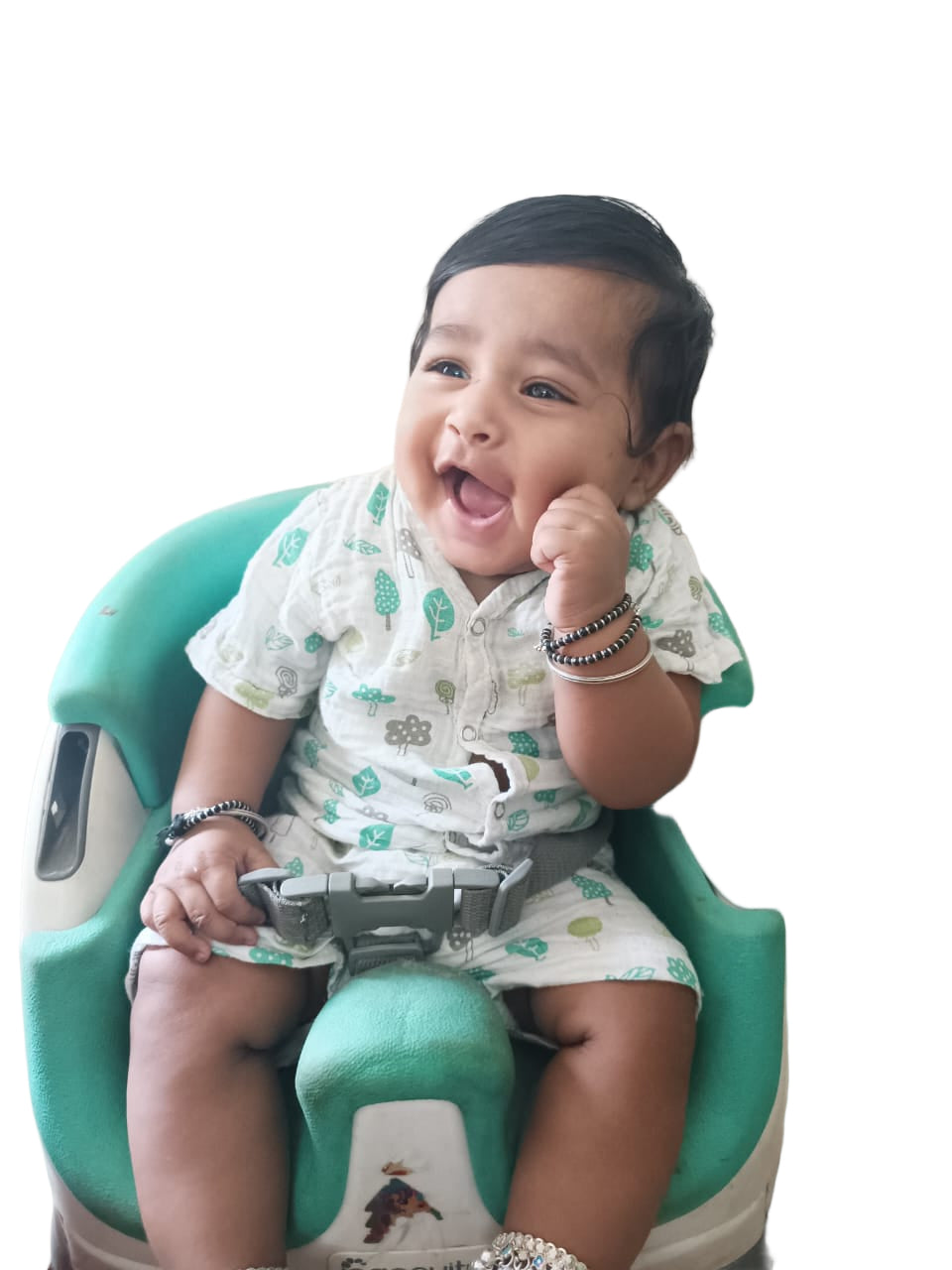 Baby sitting in a high chair with a white background
