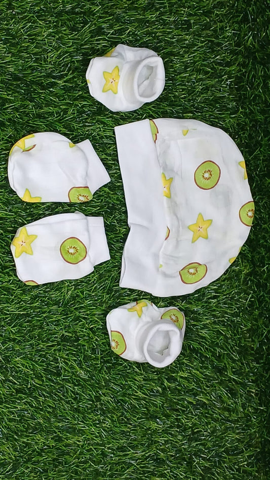 Baby clothing set with hats, bibs, and socks on grass