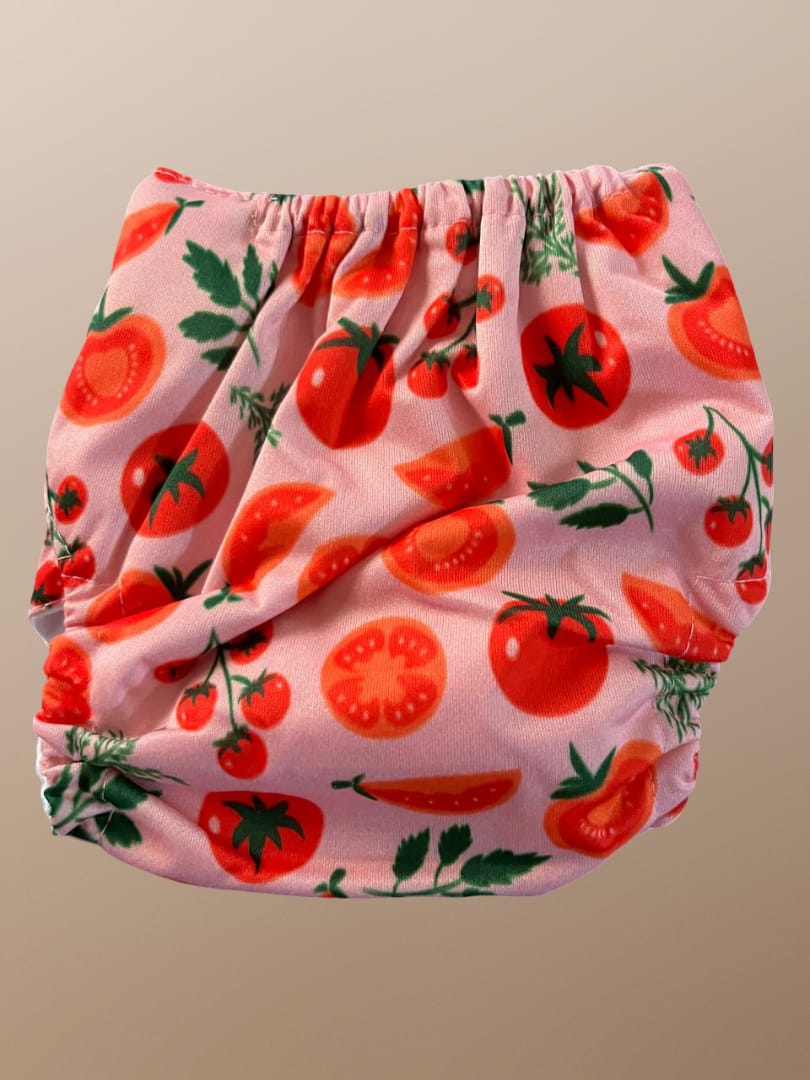 Baby bloomers with tomato pattern on a beige background